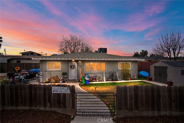 ranch-style home with a storage shed