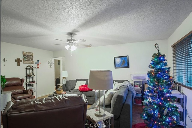 living room with ceiling fan, a textured ceiling, and hardwood / wood-style flooring