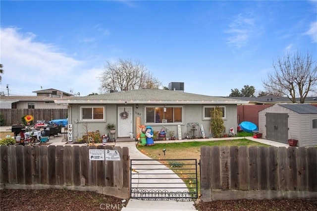 single story home featuring central air condition unit and a shed