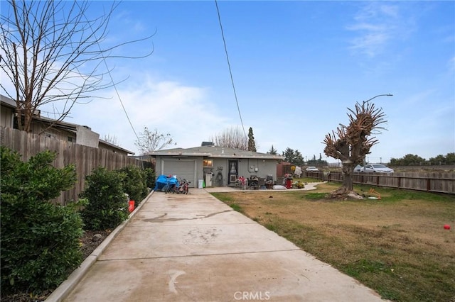 rear view of house with a garage and a lawn