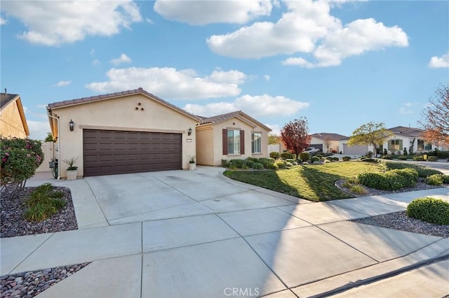 mediterranean / spanish house with a front lawn and a garage