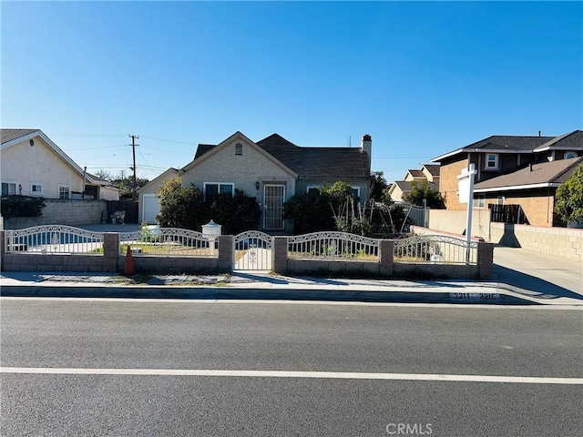 bungalow-style house with a fenced front yard and a gate