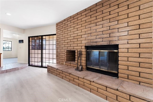 details featuring a brick fireplace and hardwood / wood-style floors