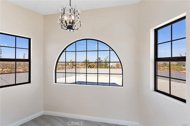 spare room featuring a chandelier