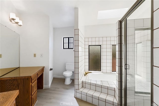 bathroom featuring hardwood / wood-style flooring, toilet, and independent shower and bath