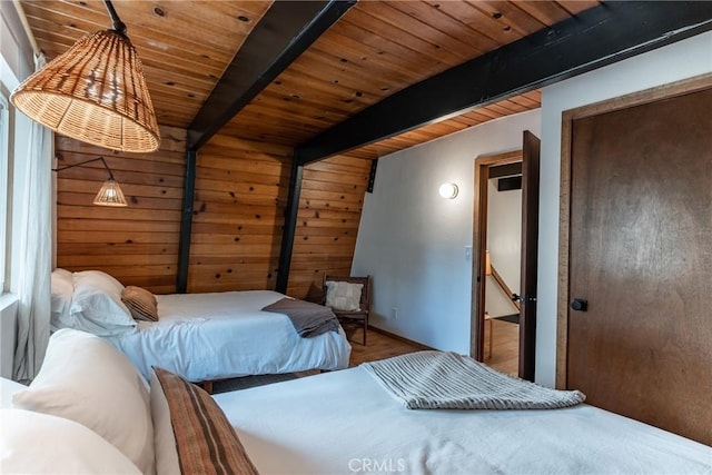 bedroom with wooden ceiling, beamed ceiling, and wood walls