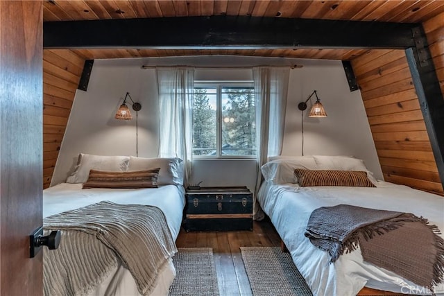 bedroom with beam ceiling, wood ceiling, wood walls, and hardwood / wood-style flooring