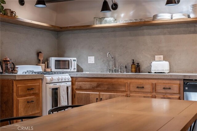 kitchen with open shelves, white range with gas cooktop, brown cabinetry, and light countertops