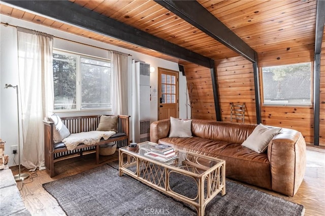 sitting room with beamed ceiling, wood walls, wood ceiling, and light hardwood / wood-style flooring