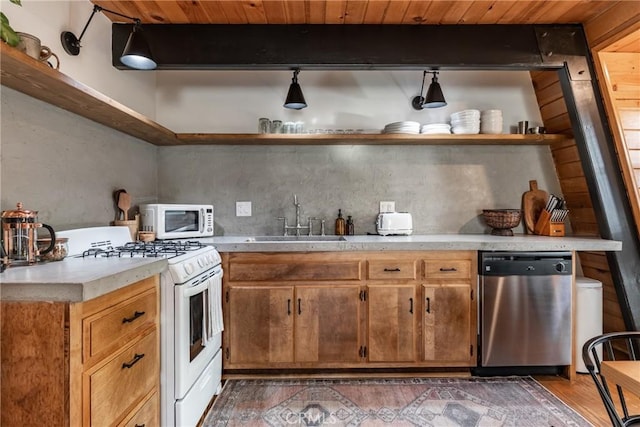 kitchen featuring sink, wood ceiling, dark hardwood / wood-style floors, beamed ceiling, and white appliances