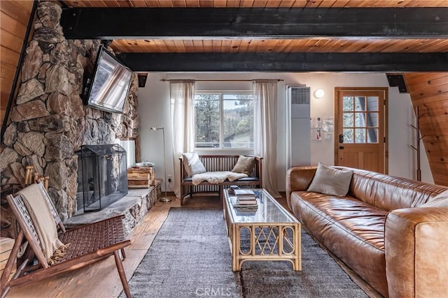 living room with wood-type flooring, a fireplace, beam ceiling, and wooden ceiling