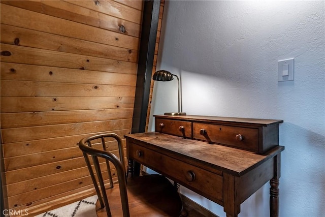 home office with wood finished floors and a textured wall