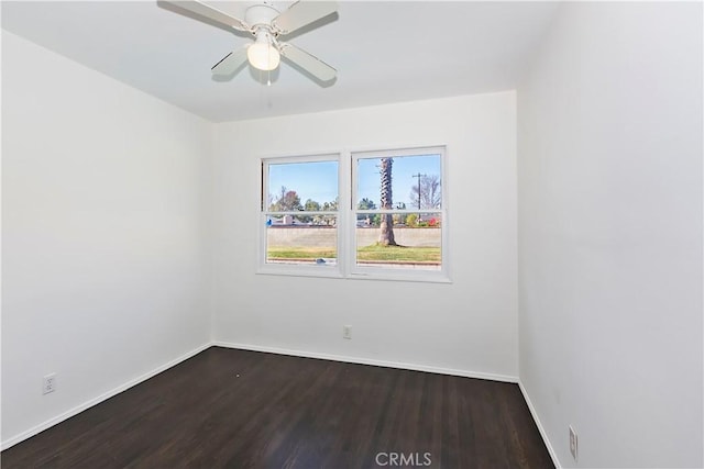 spare room with dark hardwood / wood-style floors and ceiling fan