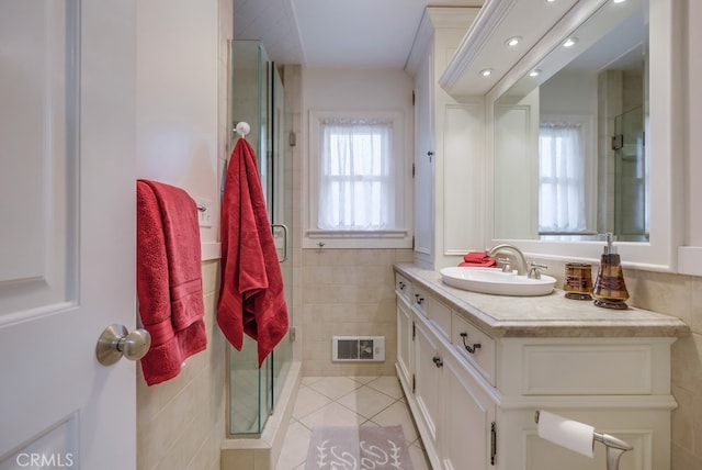 bathroom with vanity, tile patterned flooring, and a shower with door