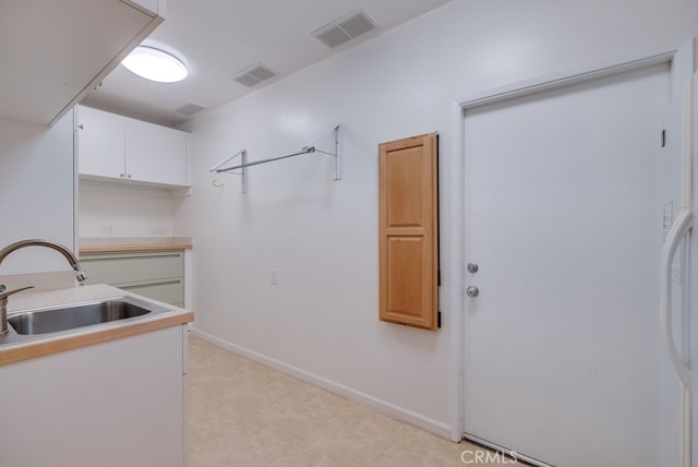 clothes washing area featuring sink