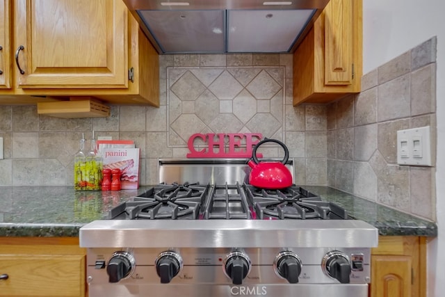 kitchen featuring backsplash, wall chimney exhaust hood, and range