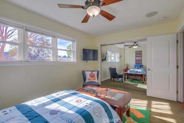 carpeted bedroom featuring a closet and ceiling fan