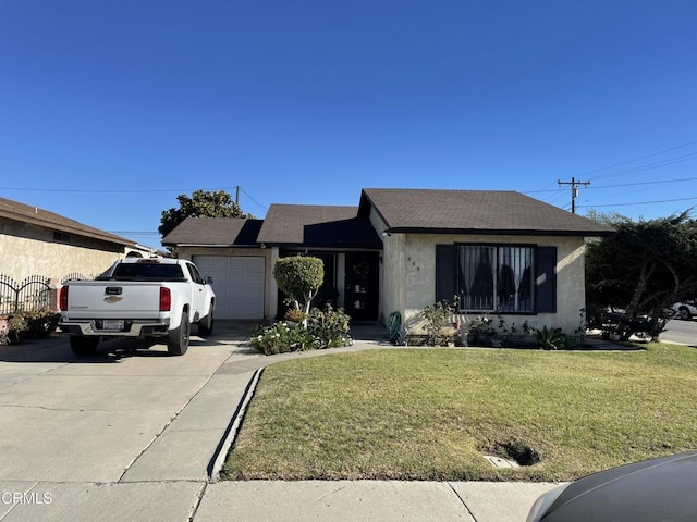 ranch-style home with a front yard and a garage