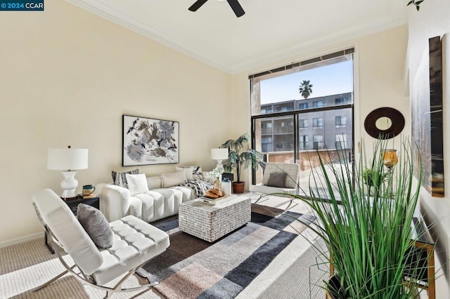 carpeted living room with ornamental molding and ceiling fan