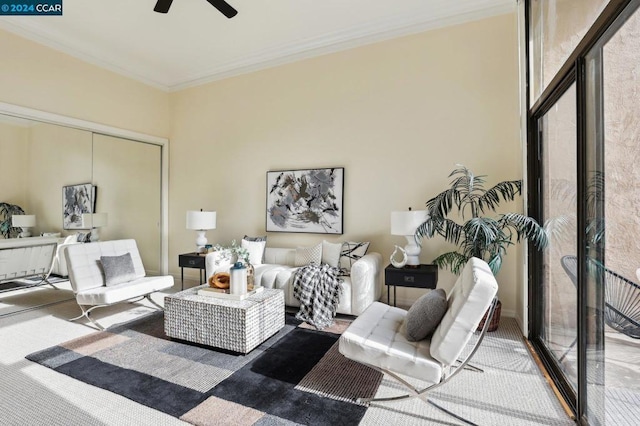 living room with ornamental molding and ceiling fan