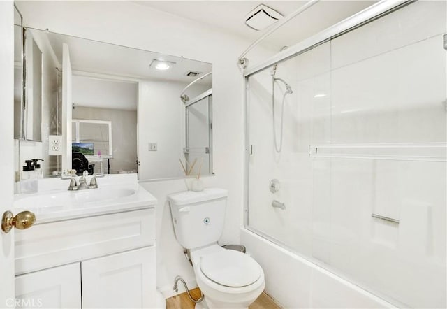 full bathroom with toilet, bath / shower combo with glass door, and vanity