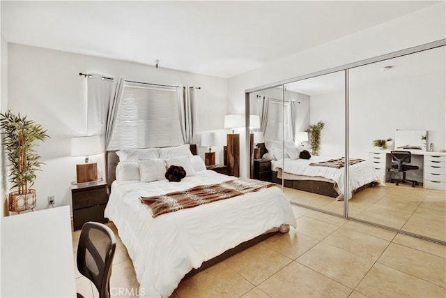 tiled bedroom with a closet