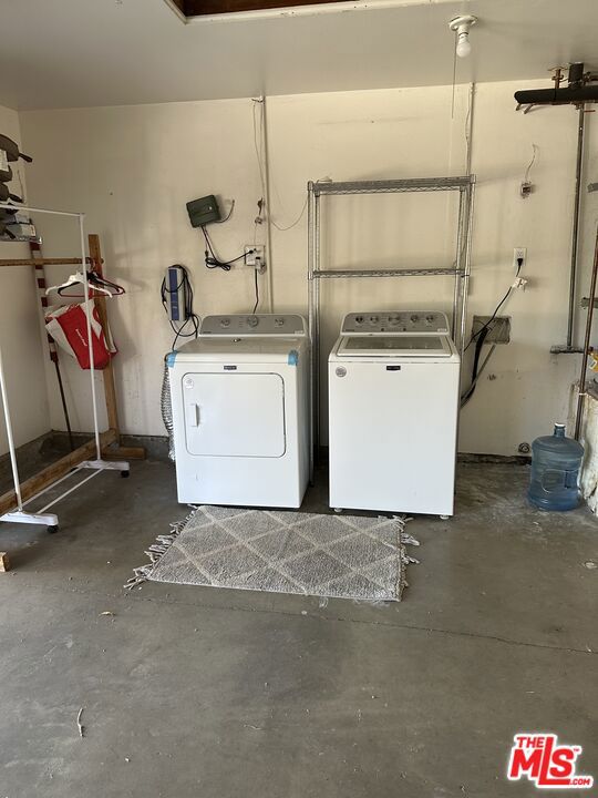 clothes washing area featuring separate washer and dryer