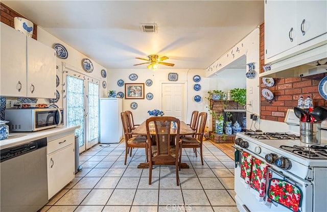 kitchen featuring white cabinets, appliances with stainless steel finishes, french doors, ceiling fan, and light tile patterned floors