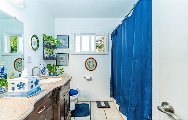 bathroom with toilet, tile patterned floors, and vanity