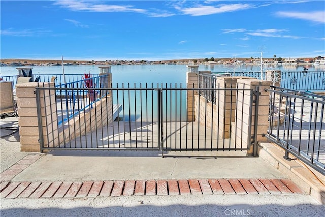 view of gate with a water view