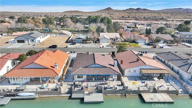 birds eye view of property with a water and mountain view