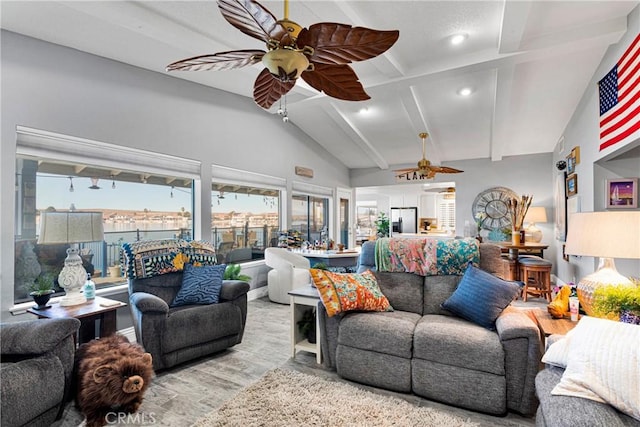 living room with ceiling fan, lofted ceiling with beams, and light hardwood / wood-style floors