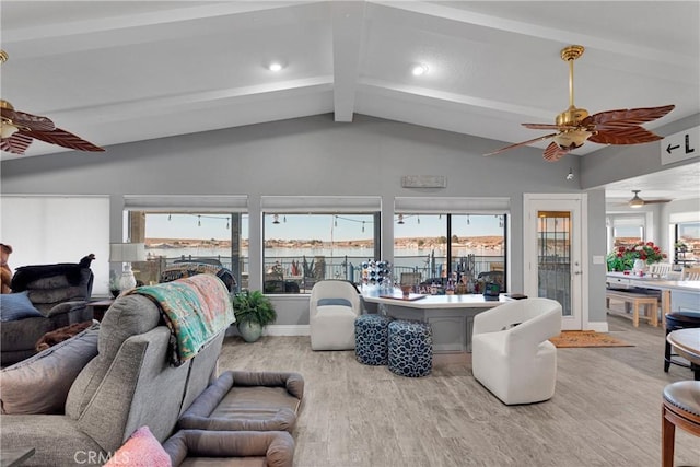 living room featuring ceiling fan, lofted ceiling with beams, and light wood-type flooring