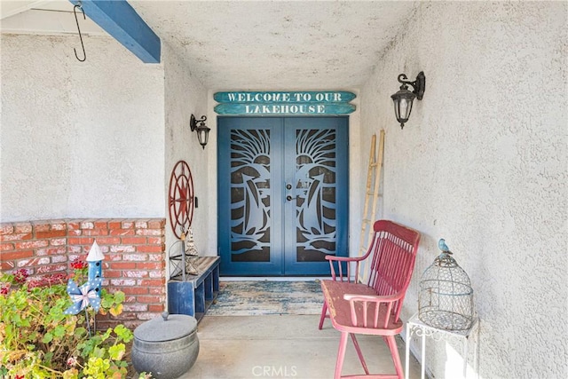 view of exterior entry featuring french doors