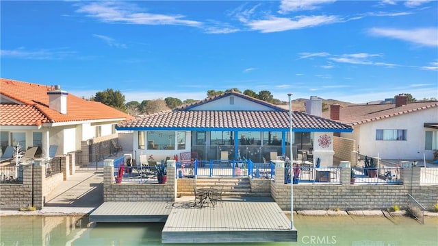 back of house featuring a water view