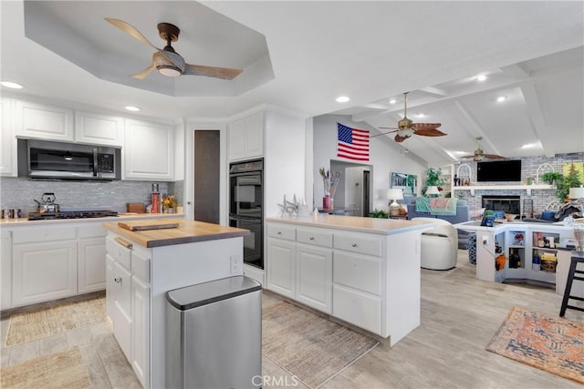 kitchen with white cabinets, stainless steel appliances, and a center island