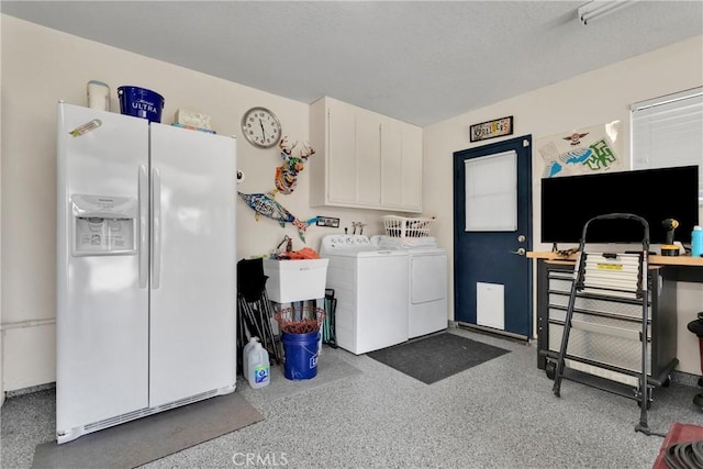 laundry room with washing machine and dryer and cabinets