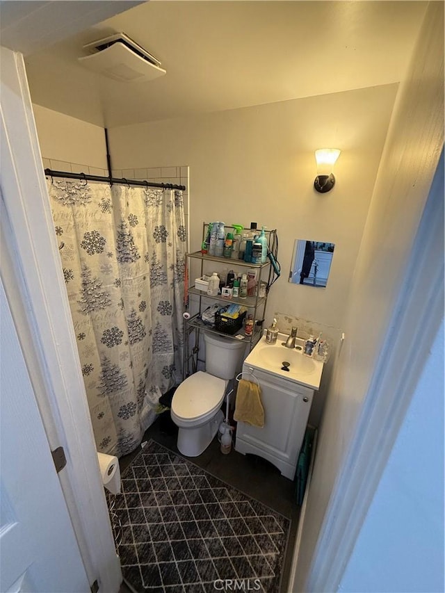 bathroom with toilet and vanity