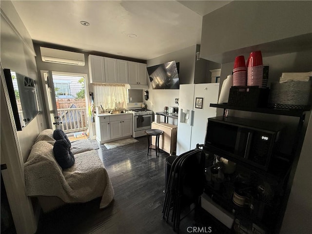 interior space with a wall mounted AC, gas stove, dark hardwood / wood-style floors, white fridge with ice dispenser, and white cabinets