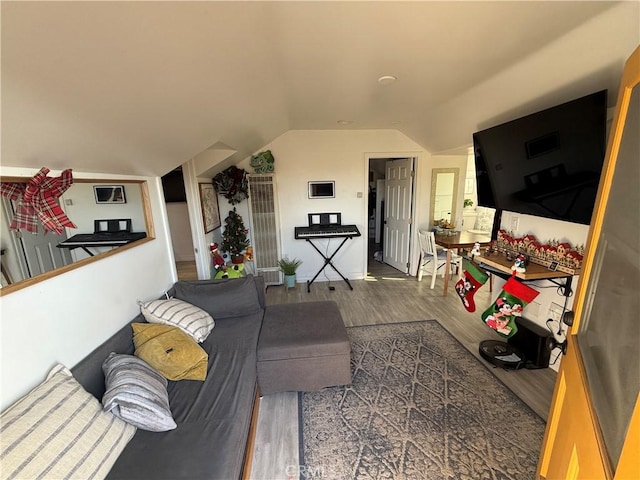 living room featuring dark hardwood / wood-style flooring and lofted ceiling