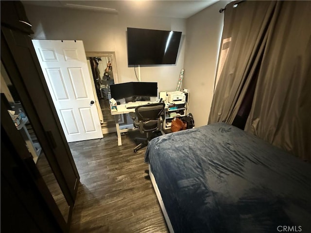 bedroom with dark hardwood / wood-style floors