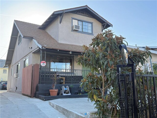 view of front of home featuring cooling unit and a porch