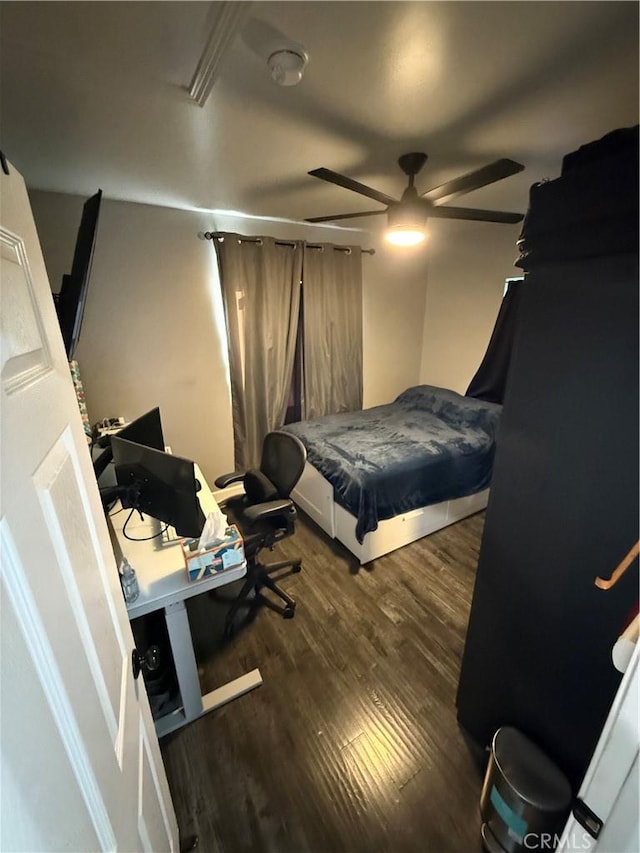 bedroom with dark wood-type flooring and ceiling fan