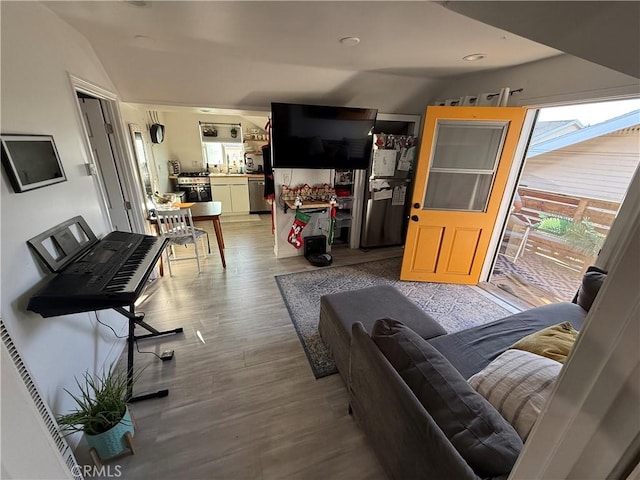 living room with vaulted ceiling and hardwood / wood-style floors