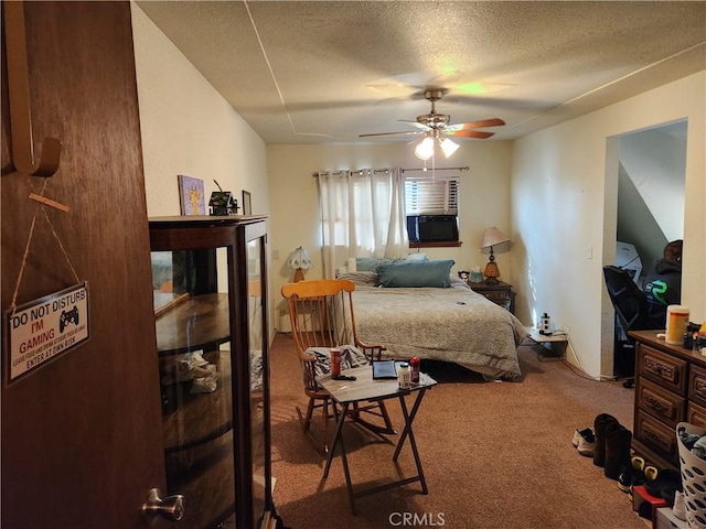 carpeted bedroom featuring ceiling fan and a textured ceiling