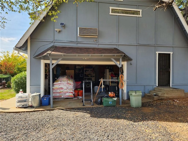 rear view of property featuring a garage