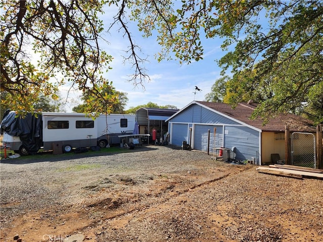 exterior space featuring a carport, an outdoor structure, and a garage