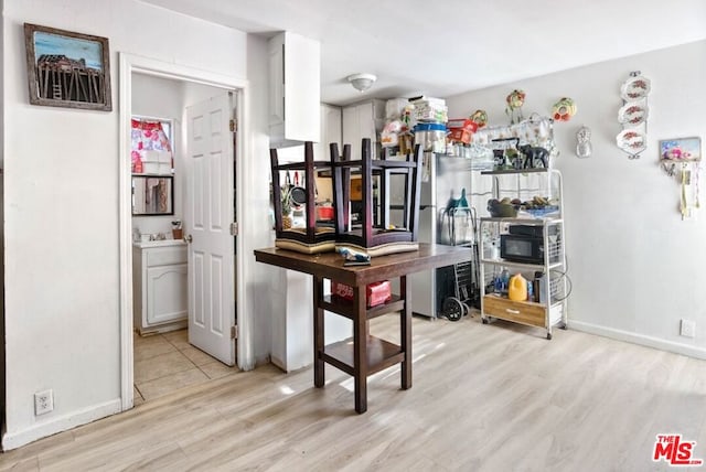 kitchen featuring light hardwood / wood-style floors and white cabinets