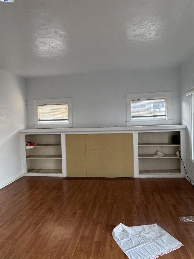 additional living space featuring dark hardwood / wood-style floors