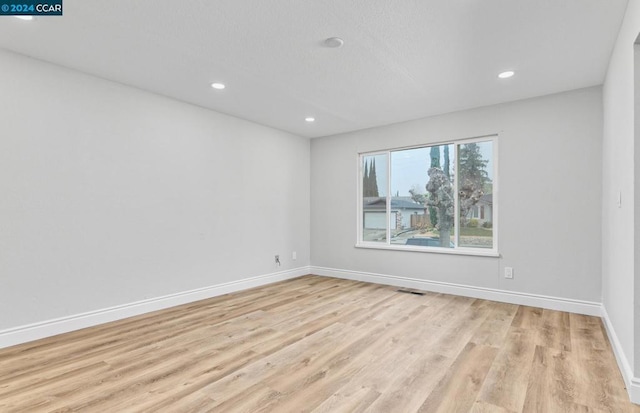 unfurnished room with light hardwood / wood-style flooring